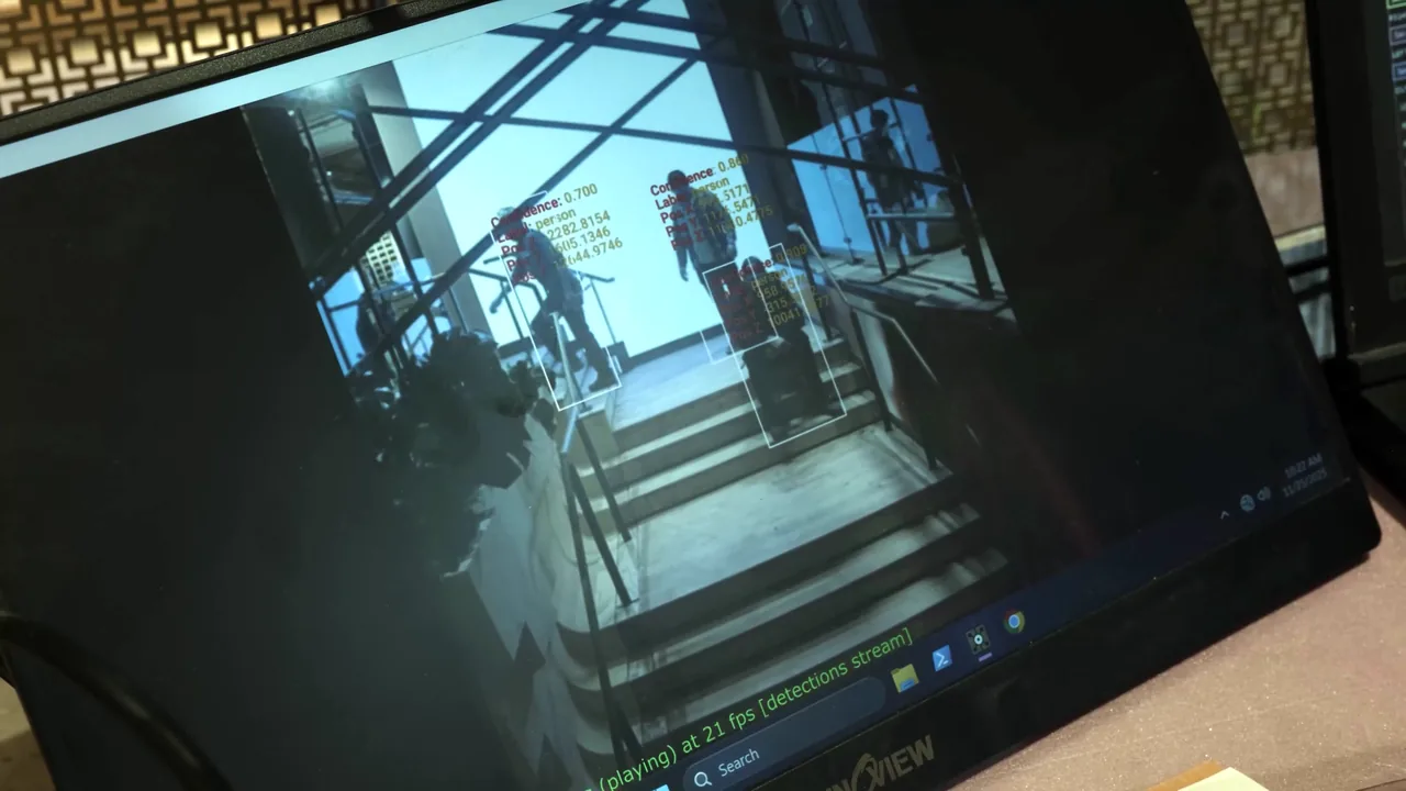 Live computer-vision people tracking during commissioning: person detections with confidence scores and X/Y/Z positions over a stairwell camera view