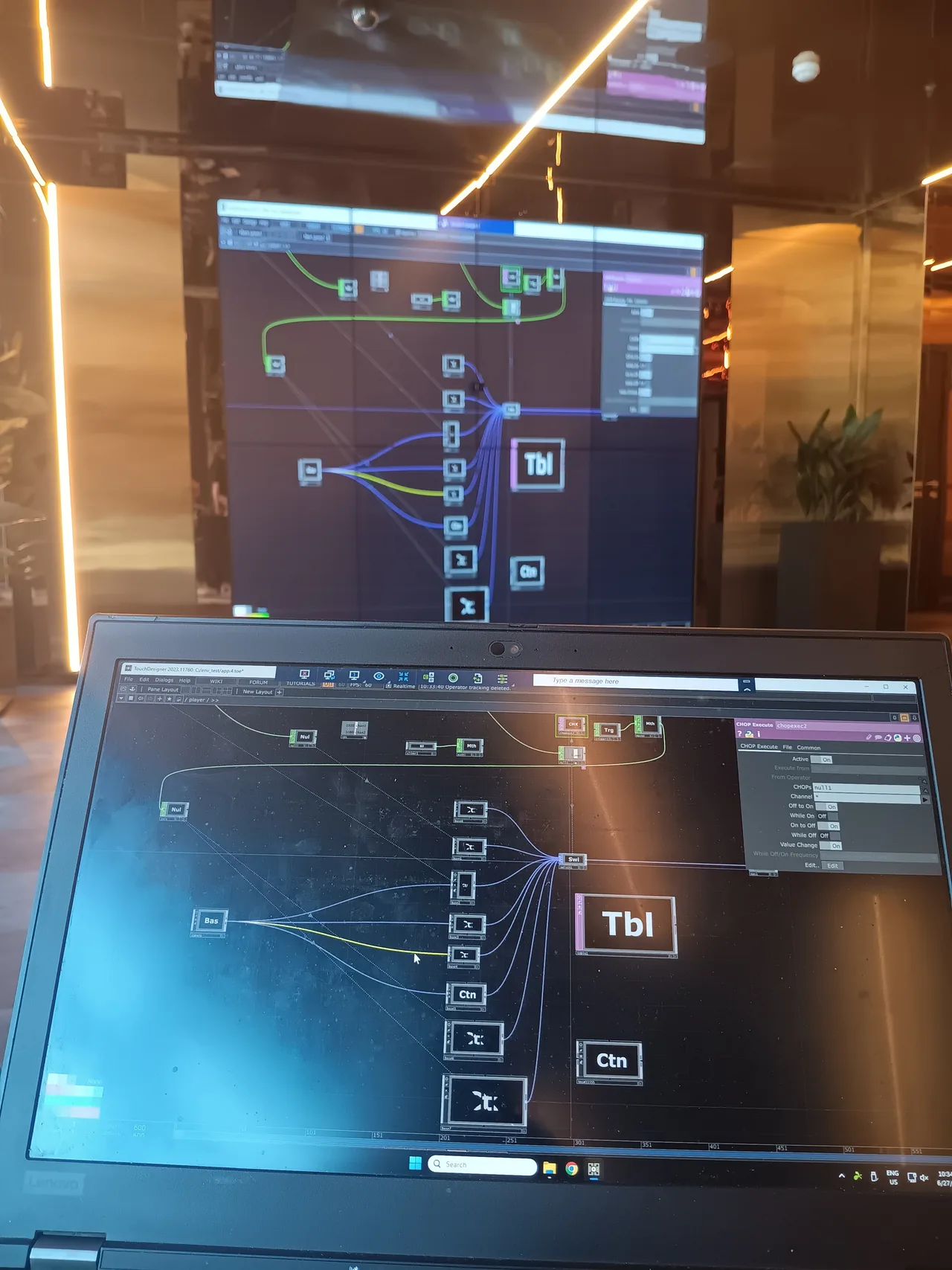 A TouchDesigner control network running on a laptop and mirrored on the installed LED wall during on-site commissioning and calibration